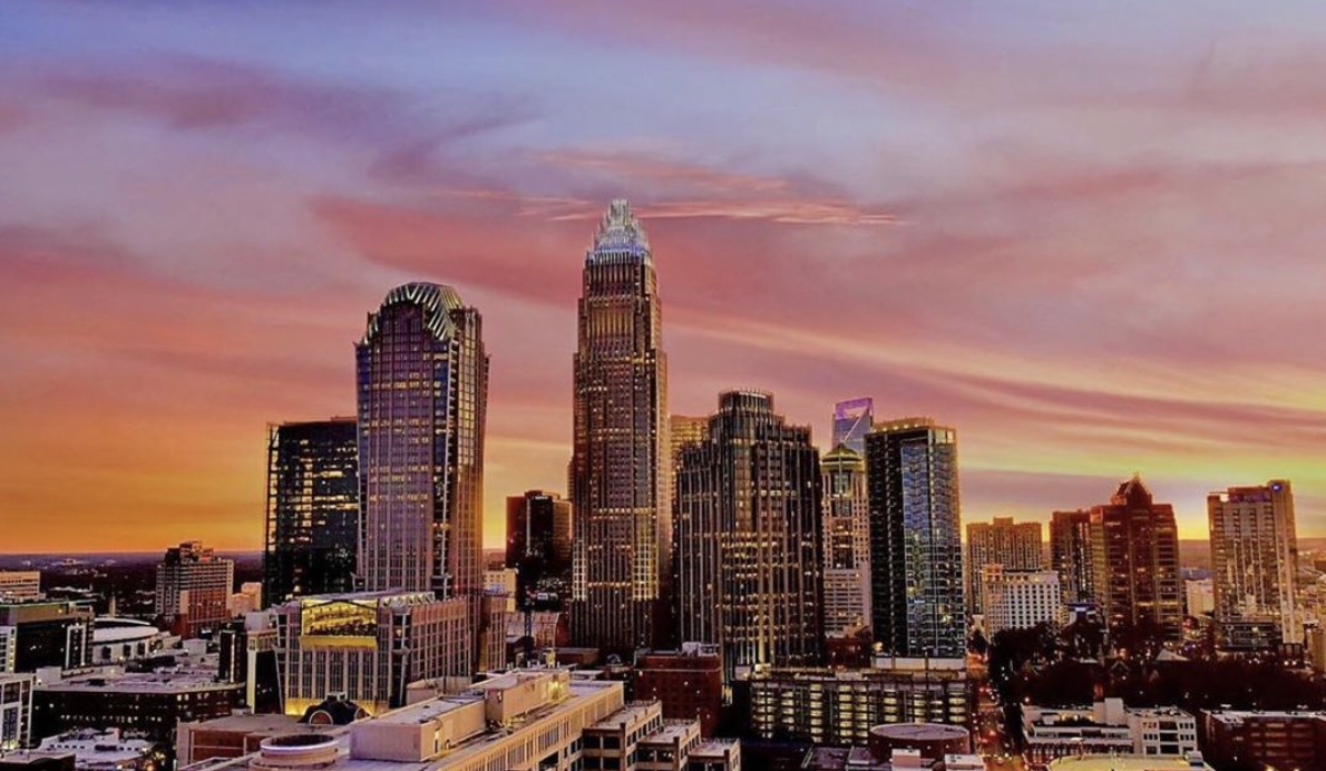 City skyline at sunset in Sir Ashley's real estate market