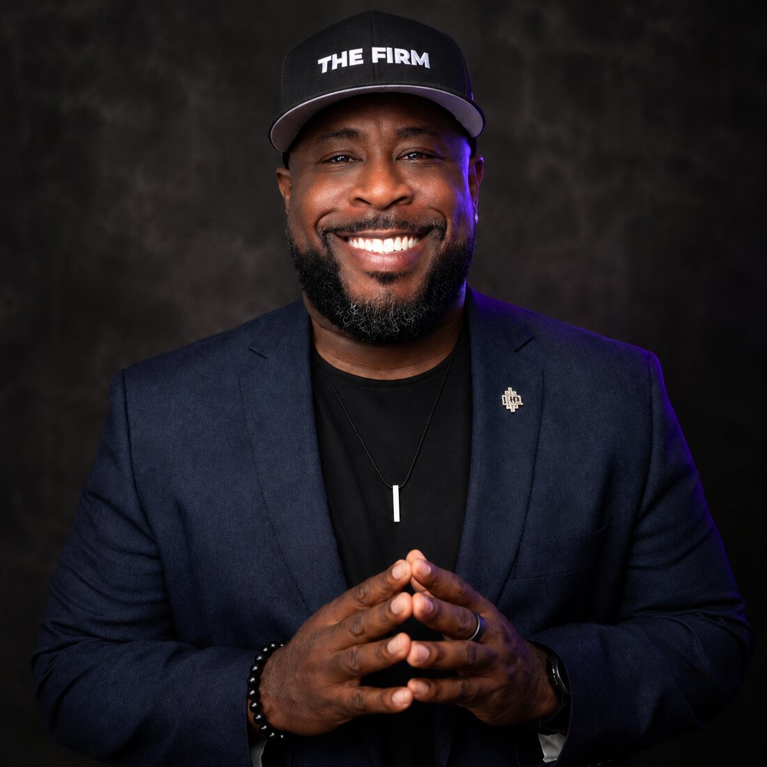 Sir Ashley Harrison, J.D., real estate advisor and broker & team leader serving Greater Charlotte, in a “The Firm” cap